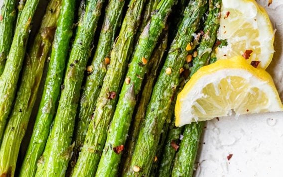 air fryer asparagus spears on a white plate