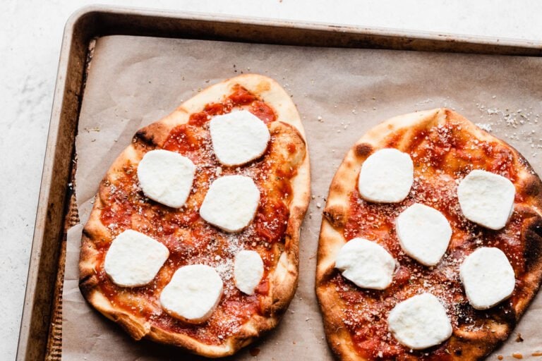 Two crusts with sauce and cheese