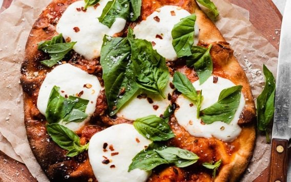 Easy naan pizza on a wooden board