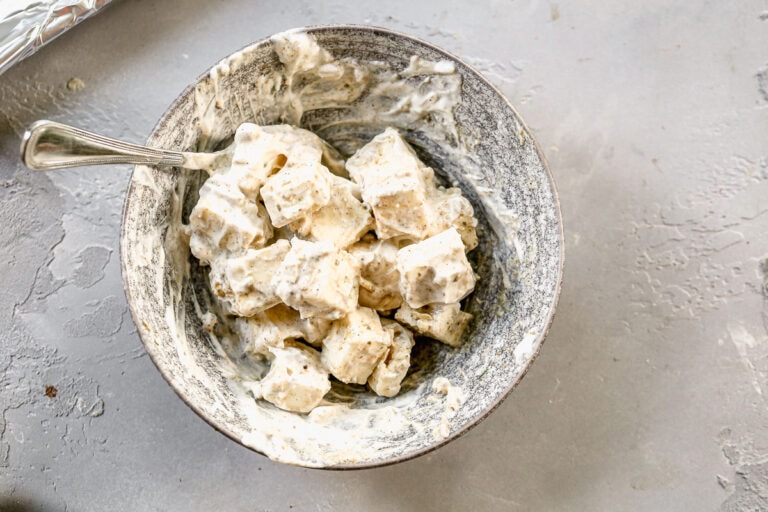 a mixture of marinating paneer, Greek yogurt, and spices