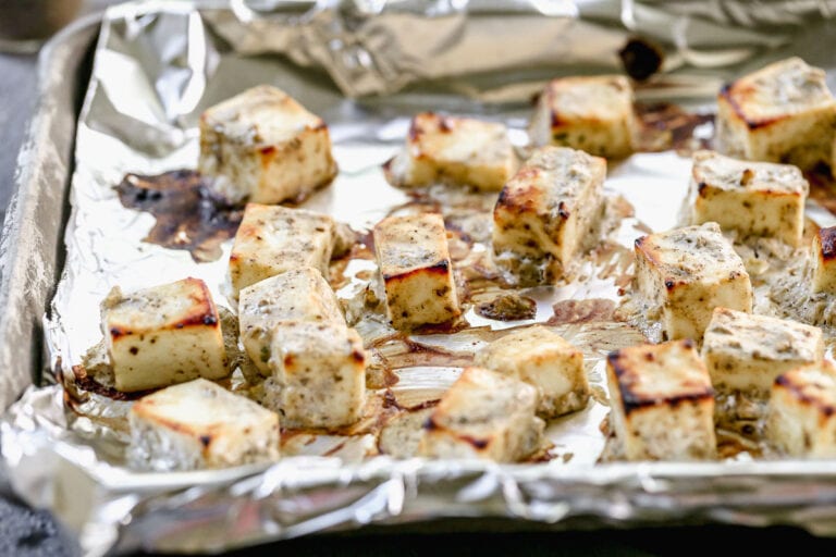 a sheet pan of baked paneer cheese for paneer tikka masala without coconut milk