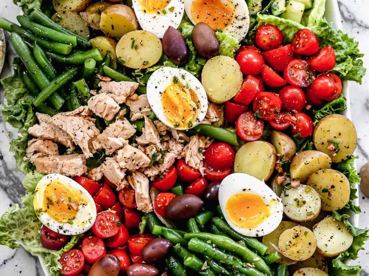 A big bowl of nicoise salad with capers