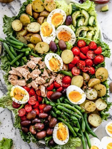A big bowl of nicoise salad with capers