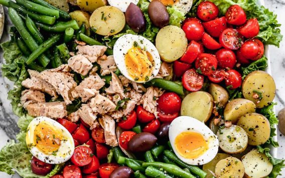 A big bowl of nicoise salad with capers