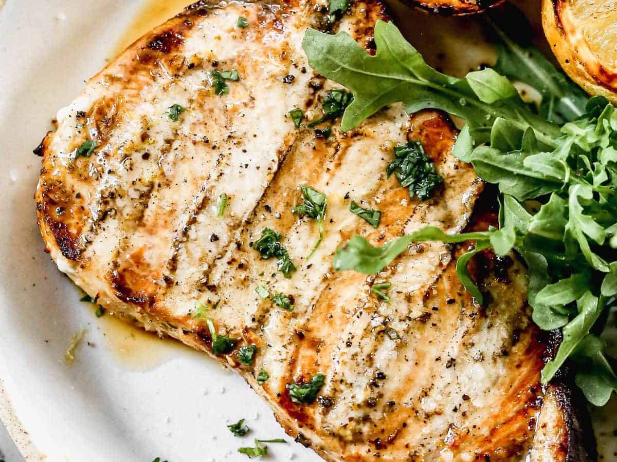 A plate with grilled lemon and swordfish