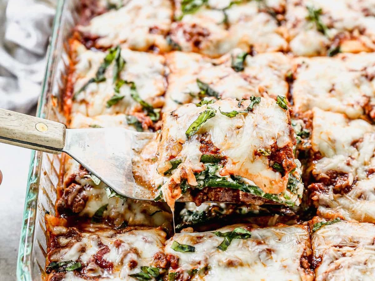 A piece of zucchini lasagna being removed with a spatula