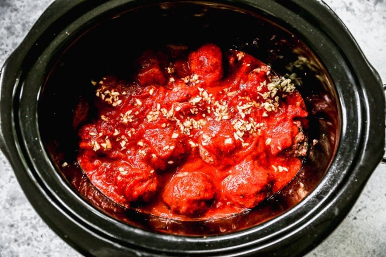 Sauce being added to a slow cooker