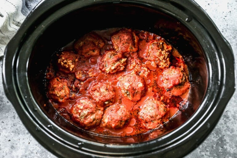 A slow cooker full of meatballs and sauce