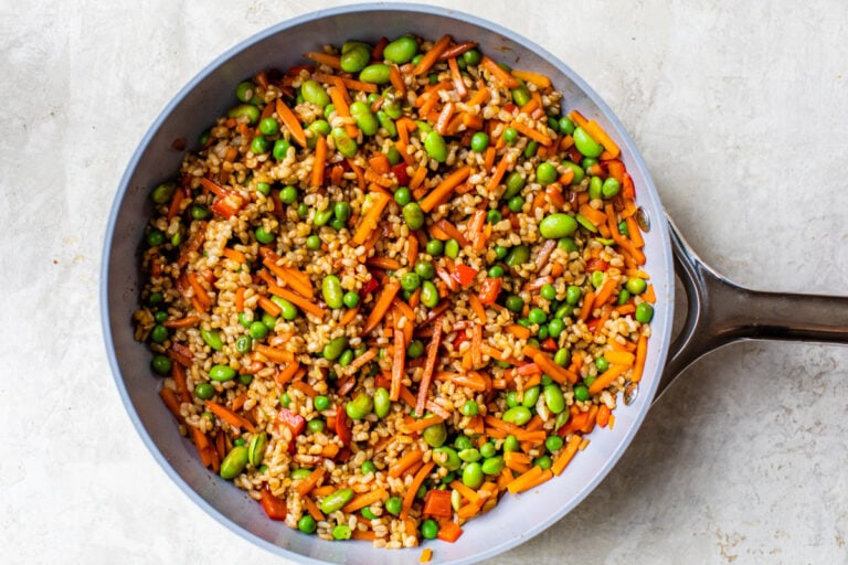 a wok with rice and vegetables