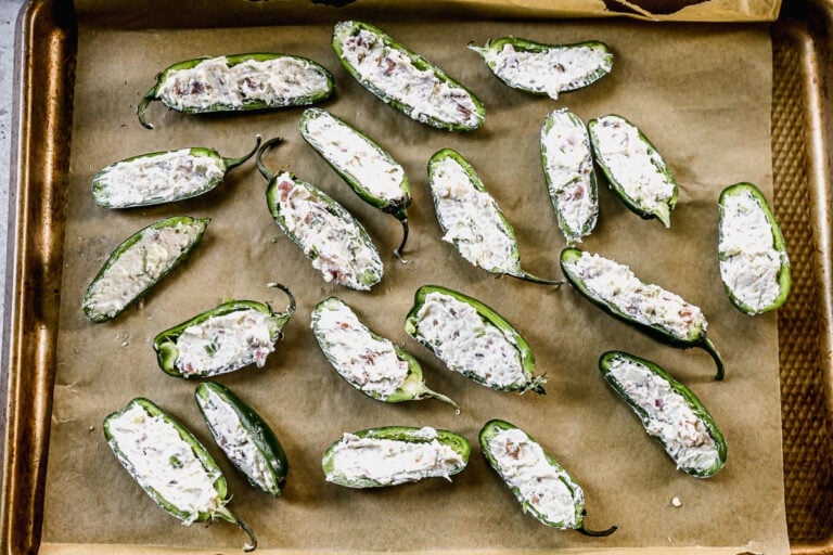 cheese jalapeno poppers on a sheet pan ready to bake in the oven