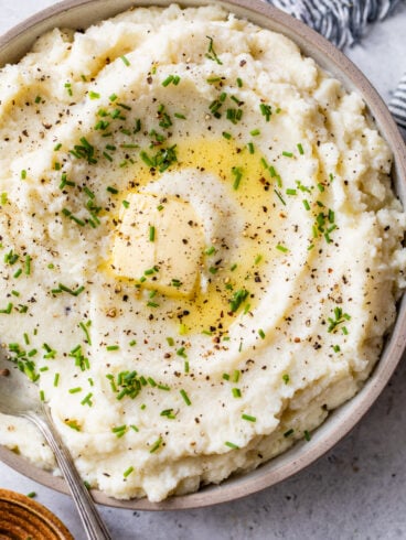 Cauliflower mashed potatoes in a bowl with chives and butter