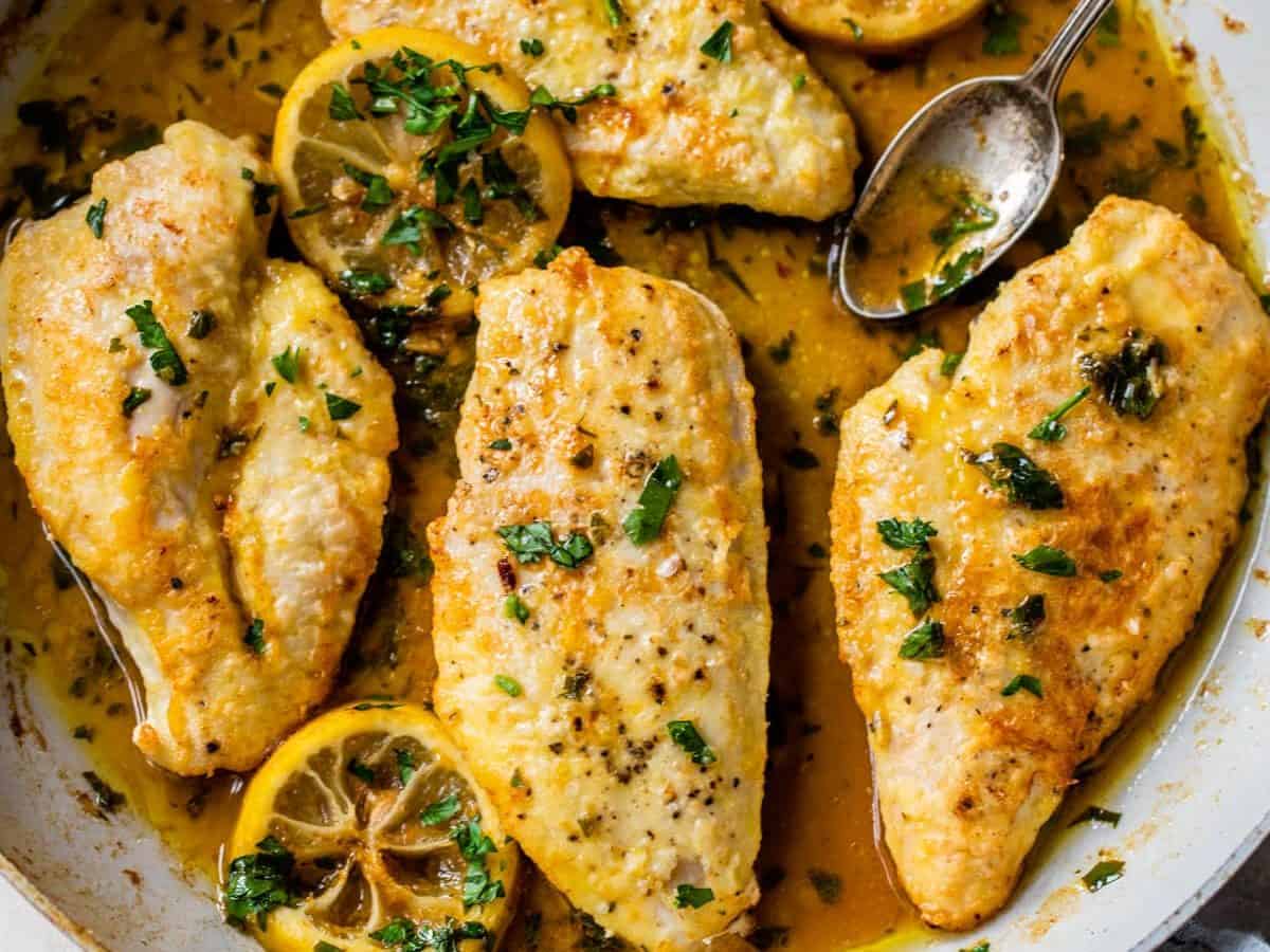 chicken francaise in a skillet with butter