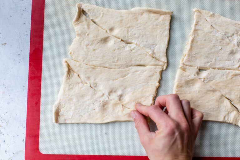 Puff pastry dough being pinched together