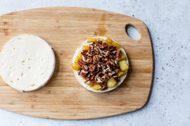 Apples and pecans on a piece of cheese
