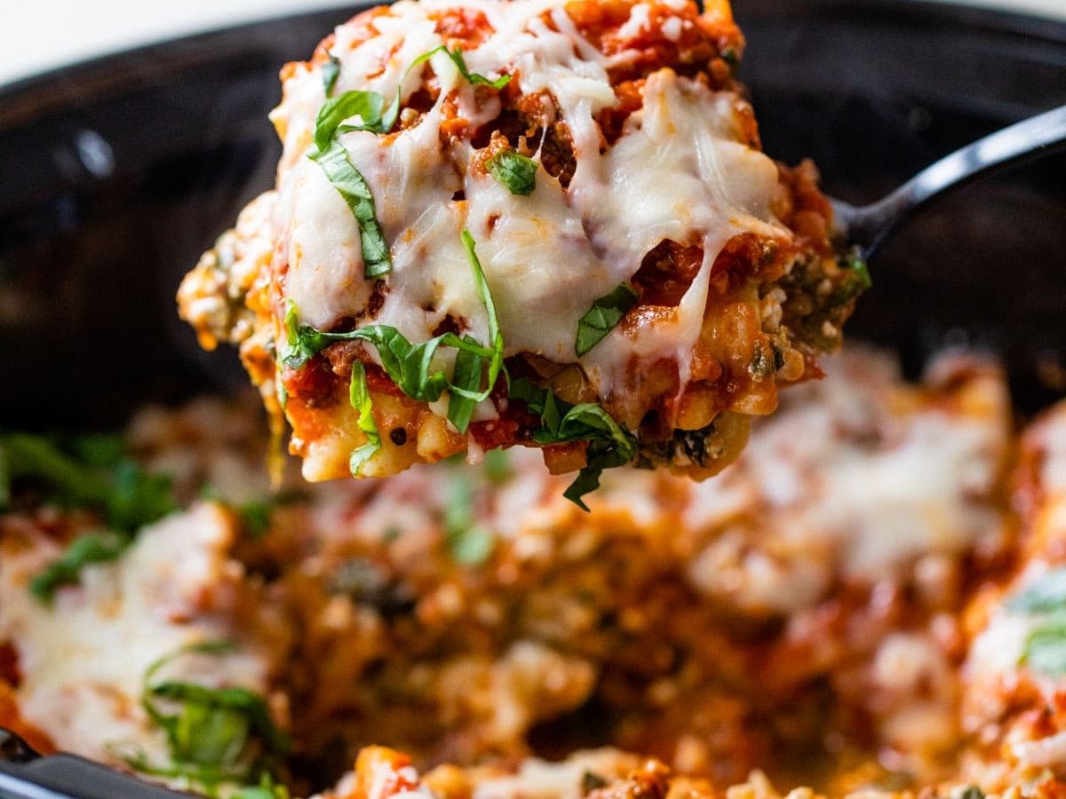 A serving of crockpot lasagna on a serving spoon