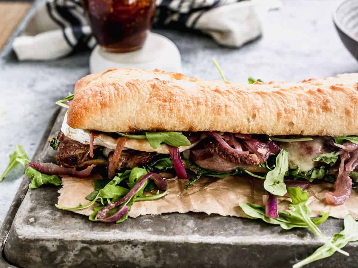 gourmet steak sandwich on ciabatta with red onions