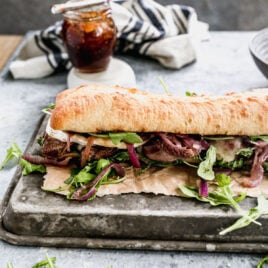 gourmet steak sandwich on ciabatta with red onions