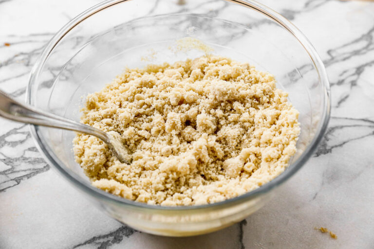 a crumbly mixture of almond flour in a bowl for gluten free pie crust