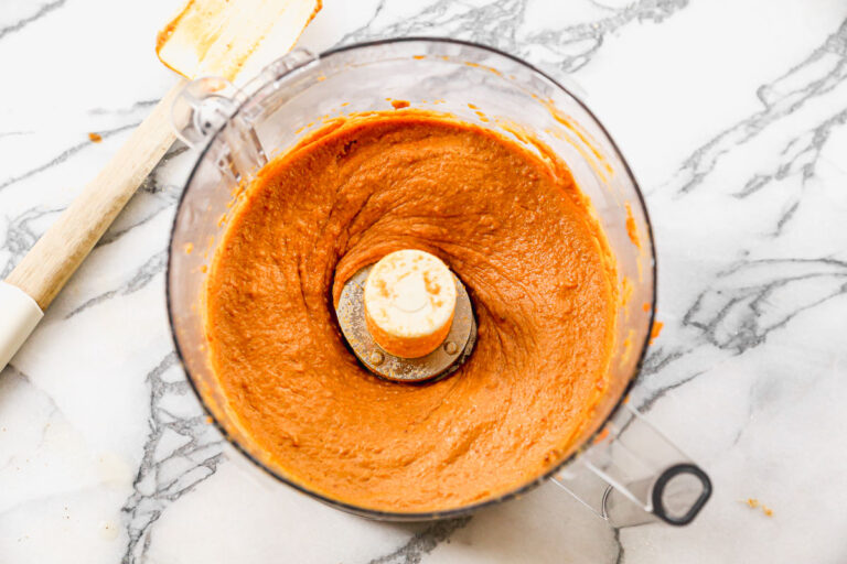a smooth mixture of vegan pumpkin pie filling in a food processor