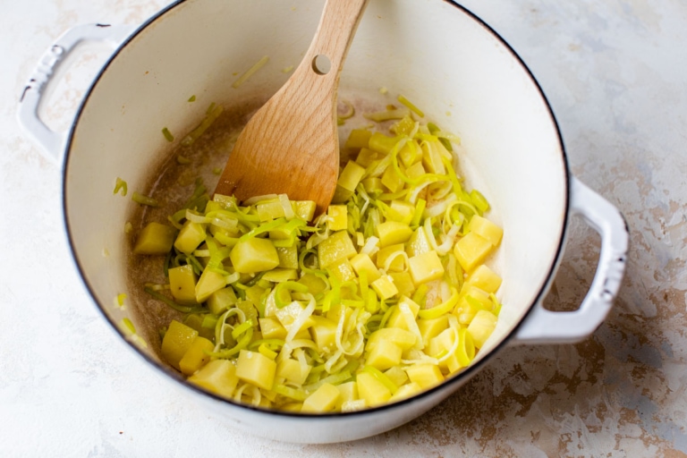 leeks cooking in a large soup pot