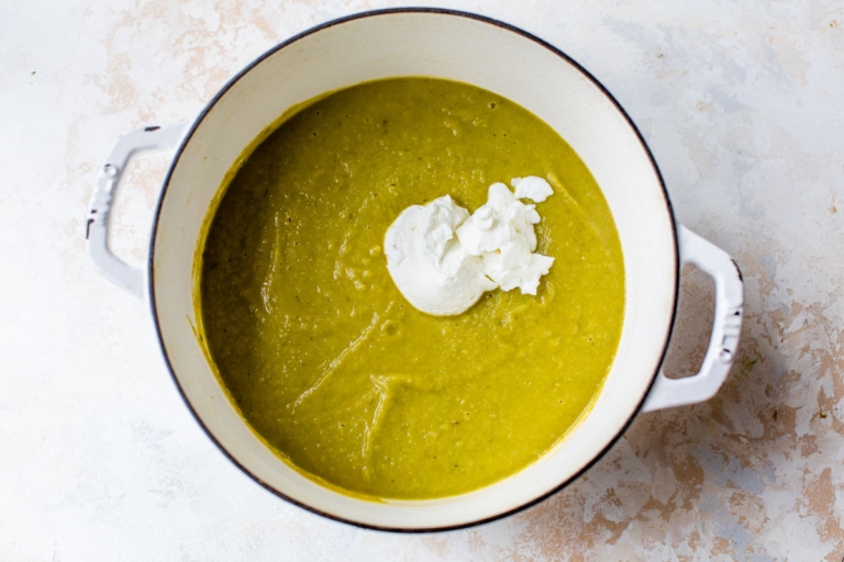 cream of asparagus soup with greek yogurt in a large pot