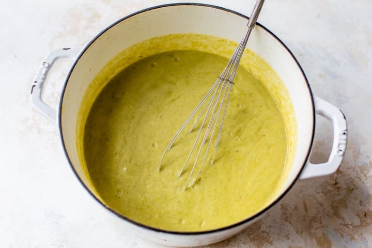 whisking together creamy vegetarian asparagus soup