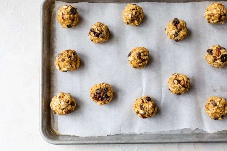rounds of oatmeal cookies on a baking sheet