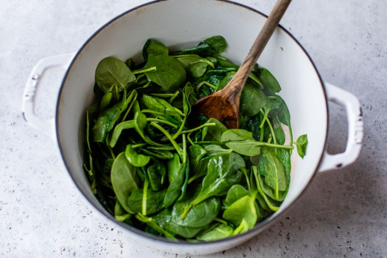 sauteeing spinach in a pot