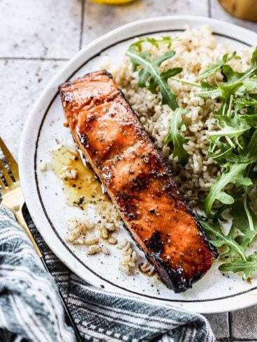 the best salmon marinade on a plate with rice and greens