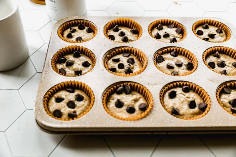 banana oatmeal muffin batter in a muffin tin