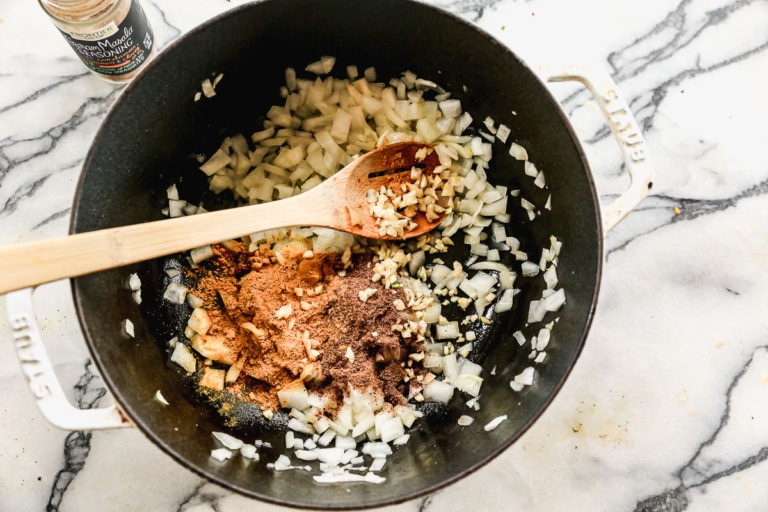 sauteeing onions and curry powder in large pot