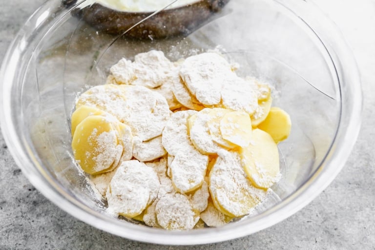 scalloped potatoes in mixing bowl