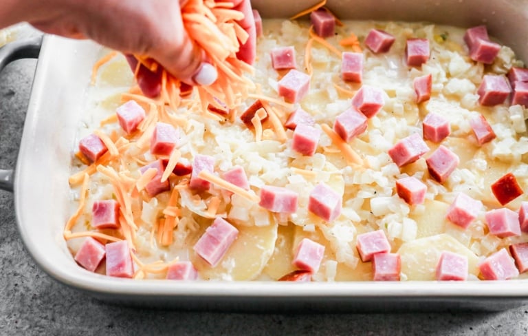 cheesy scalloped potatoes and ham in baking dish