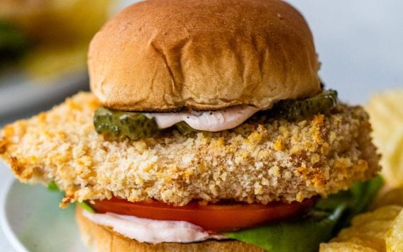 spicy chicken sandwich with spicy sauce on a plate