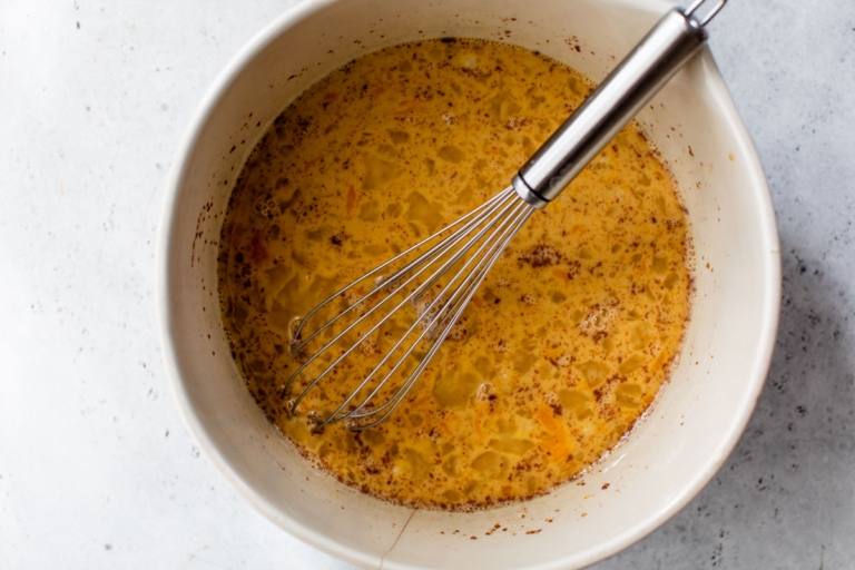 whisking together eggs for baked french toast