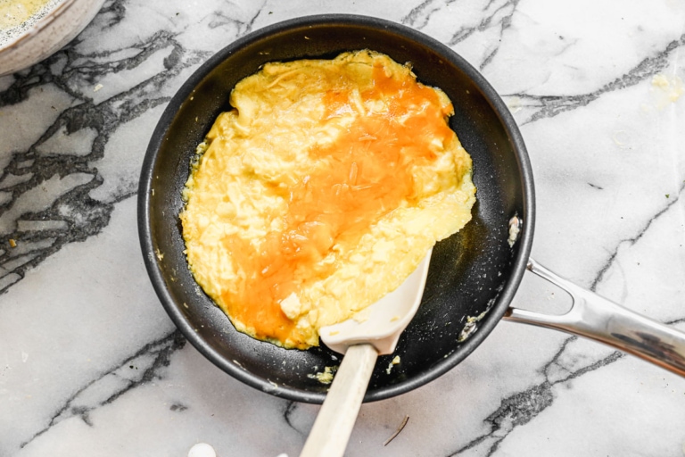 making french omelette with cheese on a pan