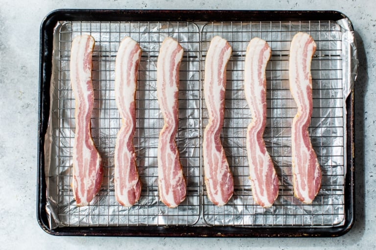 bacon on a wire baking sheet to bake in oven