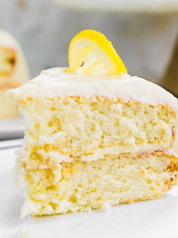 Slice of lemon layer cake on white plate