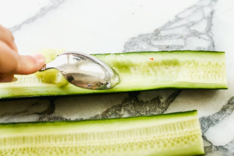 scooping out english cucumber for avocado salad