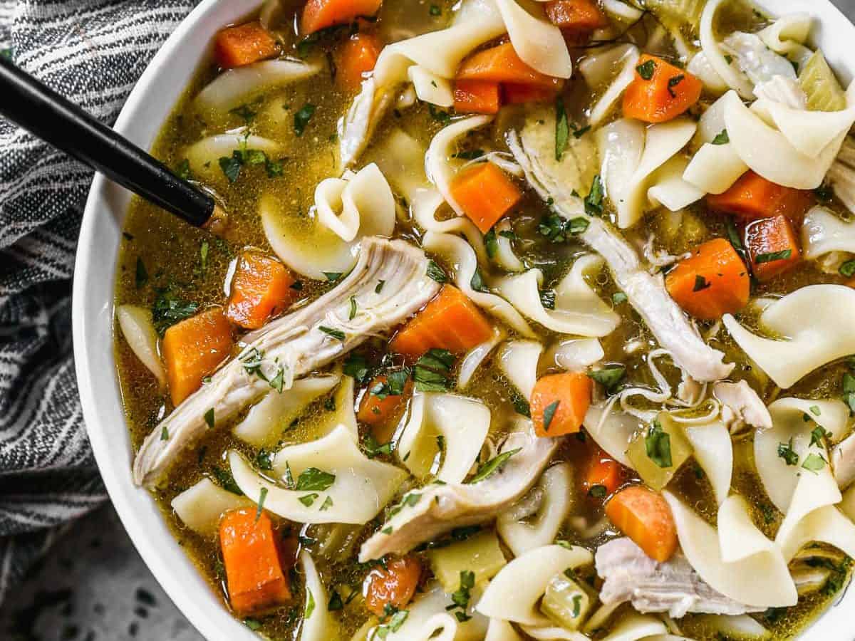 bowl of chicken noodle soup with egg noodles