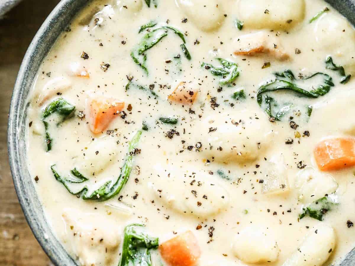 a bowl of creamy copycat olive garden chicken and gnocchi soup