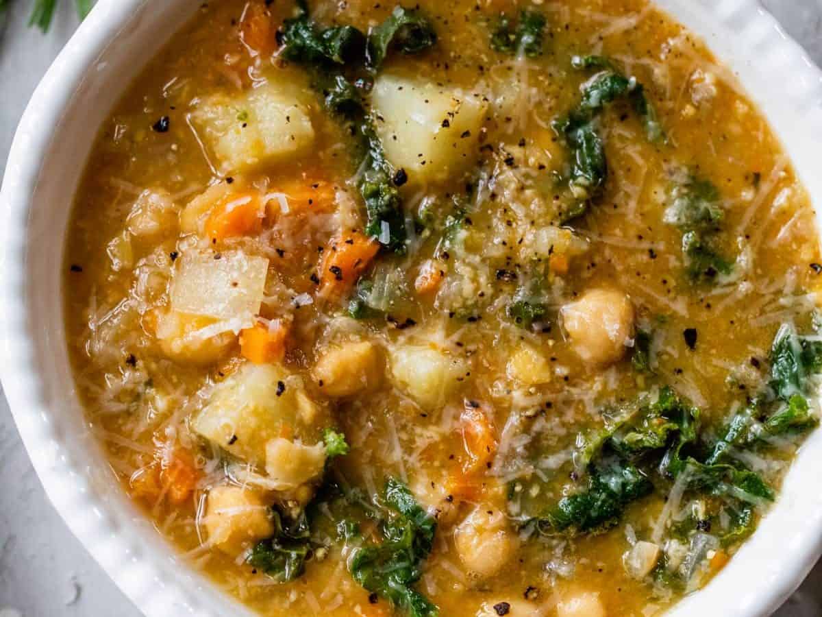 a bowl of chickpea soup with carrots and potatoes
