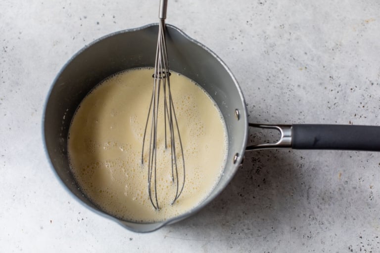 butter, broth, and milk simmering for the best mashed potatoes recipe
