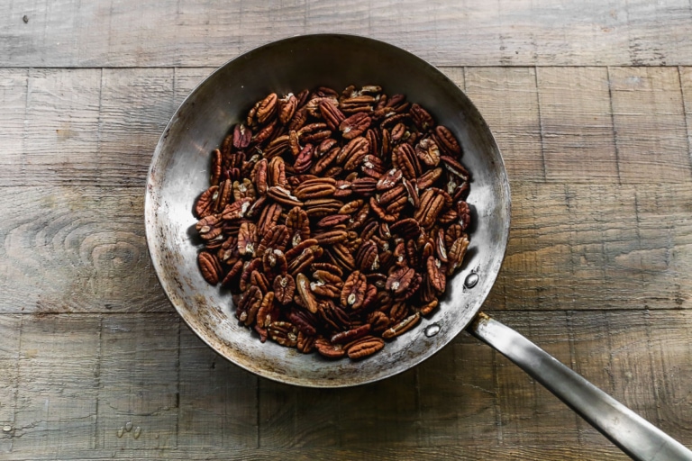toasted pecans in hot skillet for chocolate pecan pie recipe