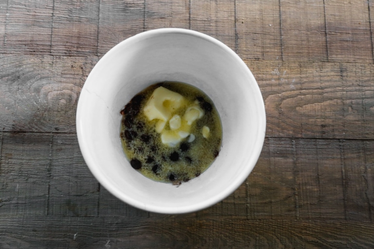 butter and chocolate chips melting in a bowl for chocolate pecan pie recipe