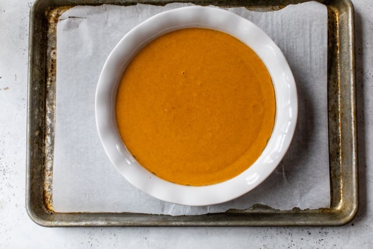 a pie pan filled with crustless pumpkin pie filling