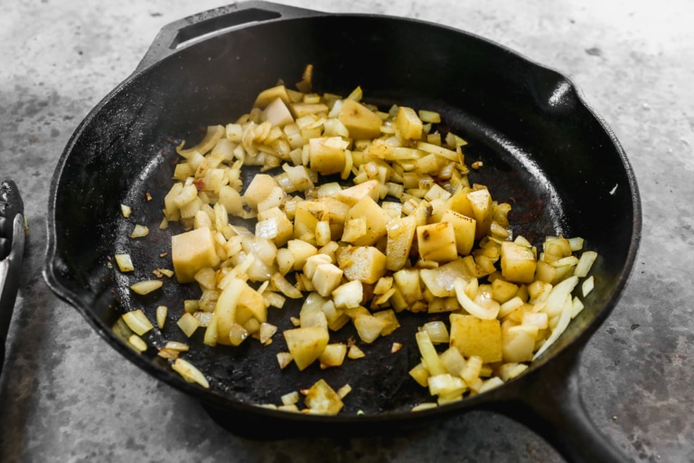 potatoes and onions in a skillet making indian shrimp curry recipe