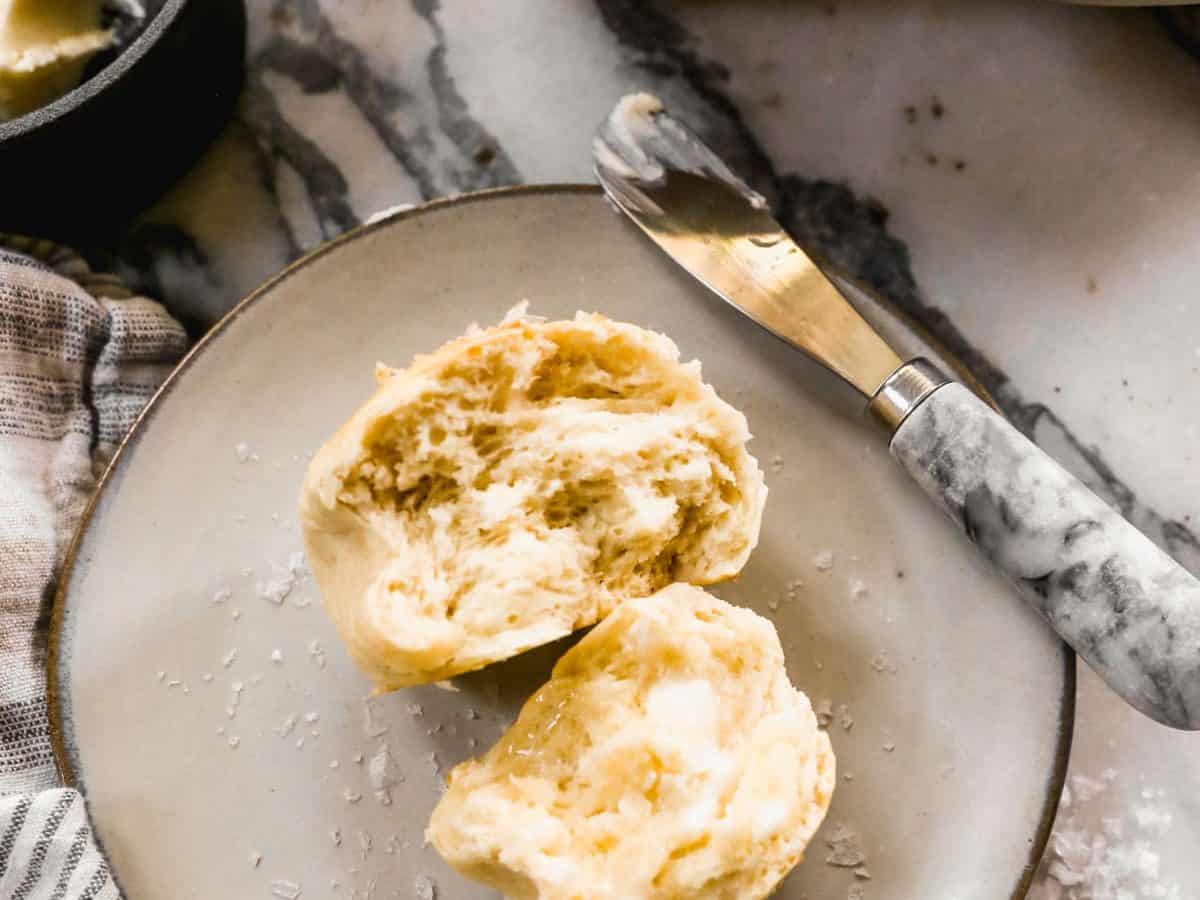 homemade dinner roll with butter on a plate