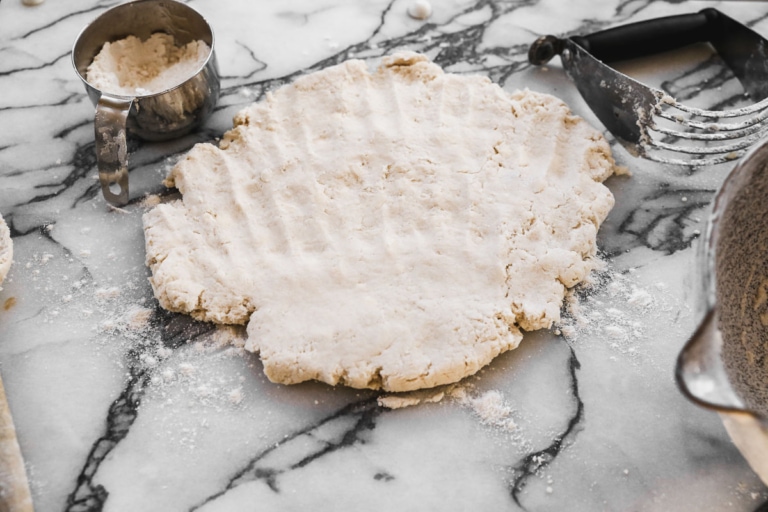 breakfast biscuit dough rolled out on floured surface