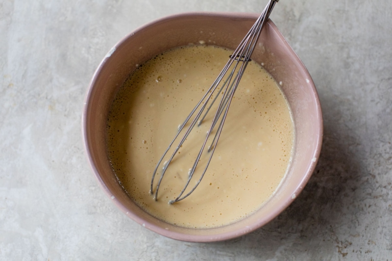 whisking together ingredients for skillet cornbread recipe